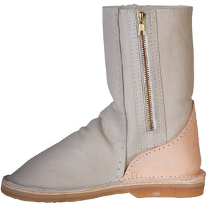 Beige ankle boot with a gold zipper on a white background